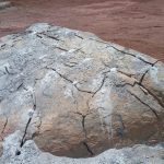 drilling and puring of rock breaking chemical on massive boulders on a mine